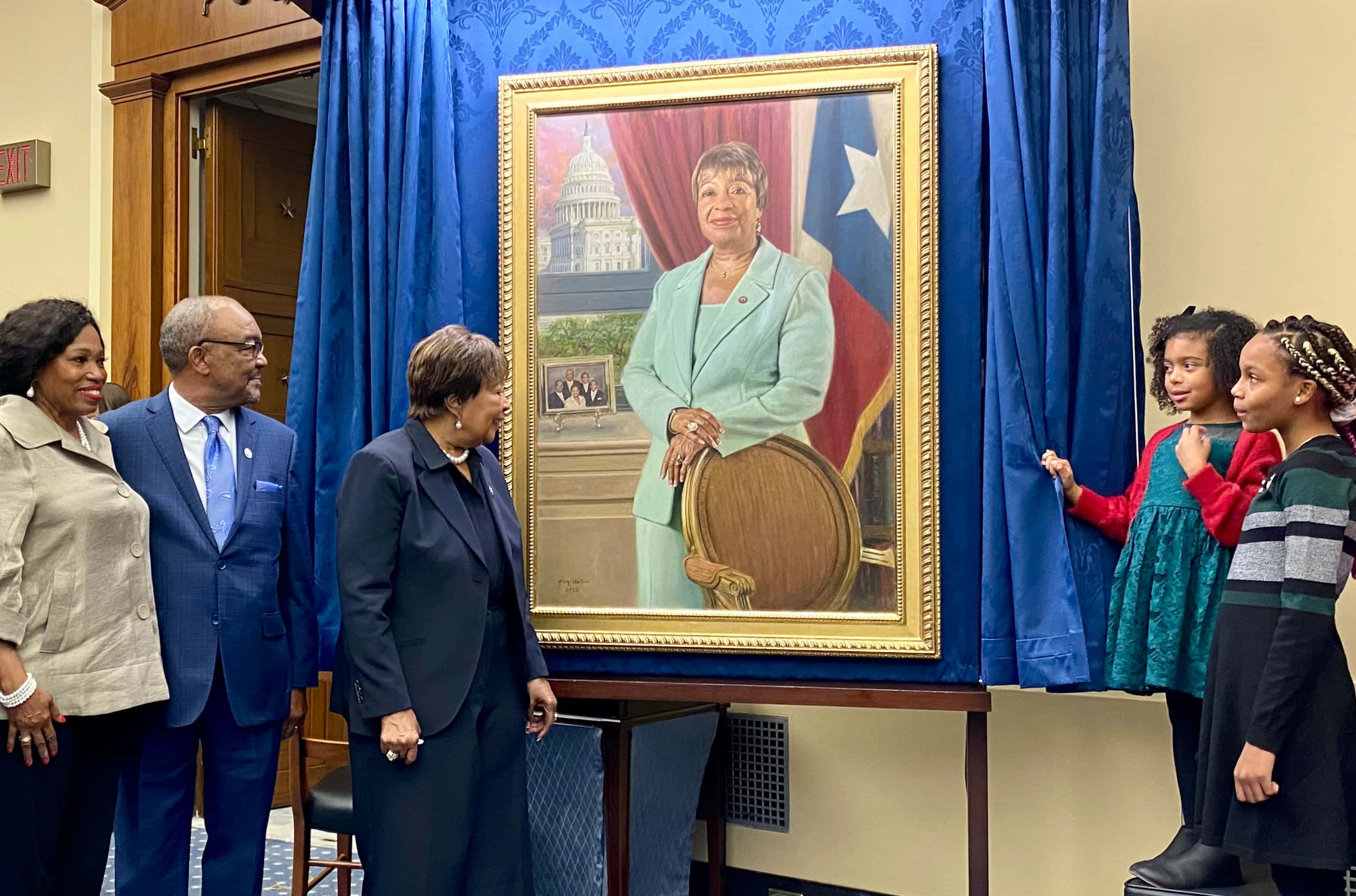 Rep. Eddie Bernice Johnson, D-Dallas, center, looks at her official portrait, with family,...