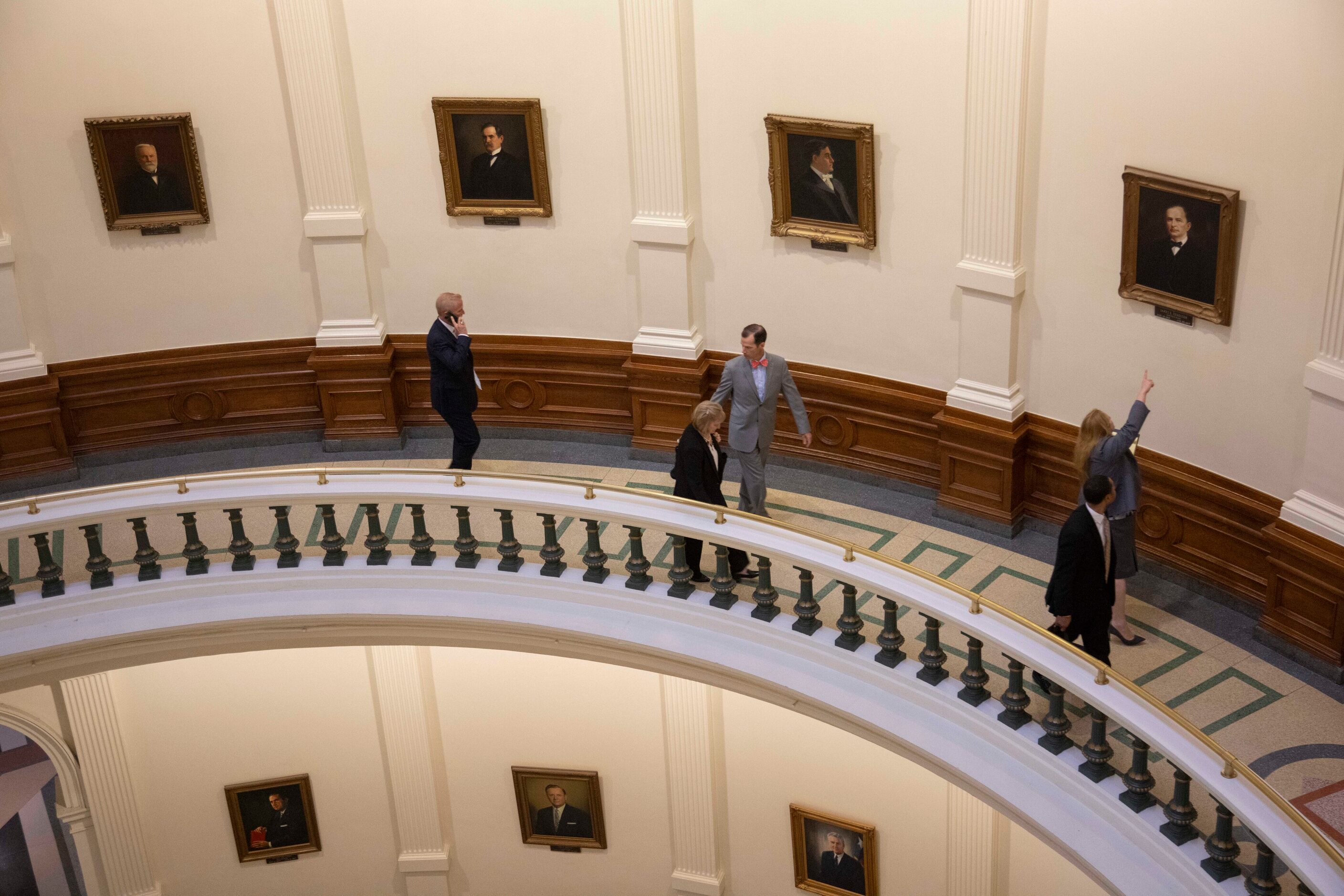 Member’s of the House impeachment team look and point at the portrait of Gov. James “Pa”...