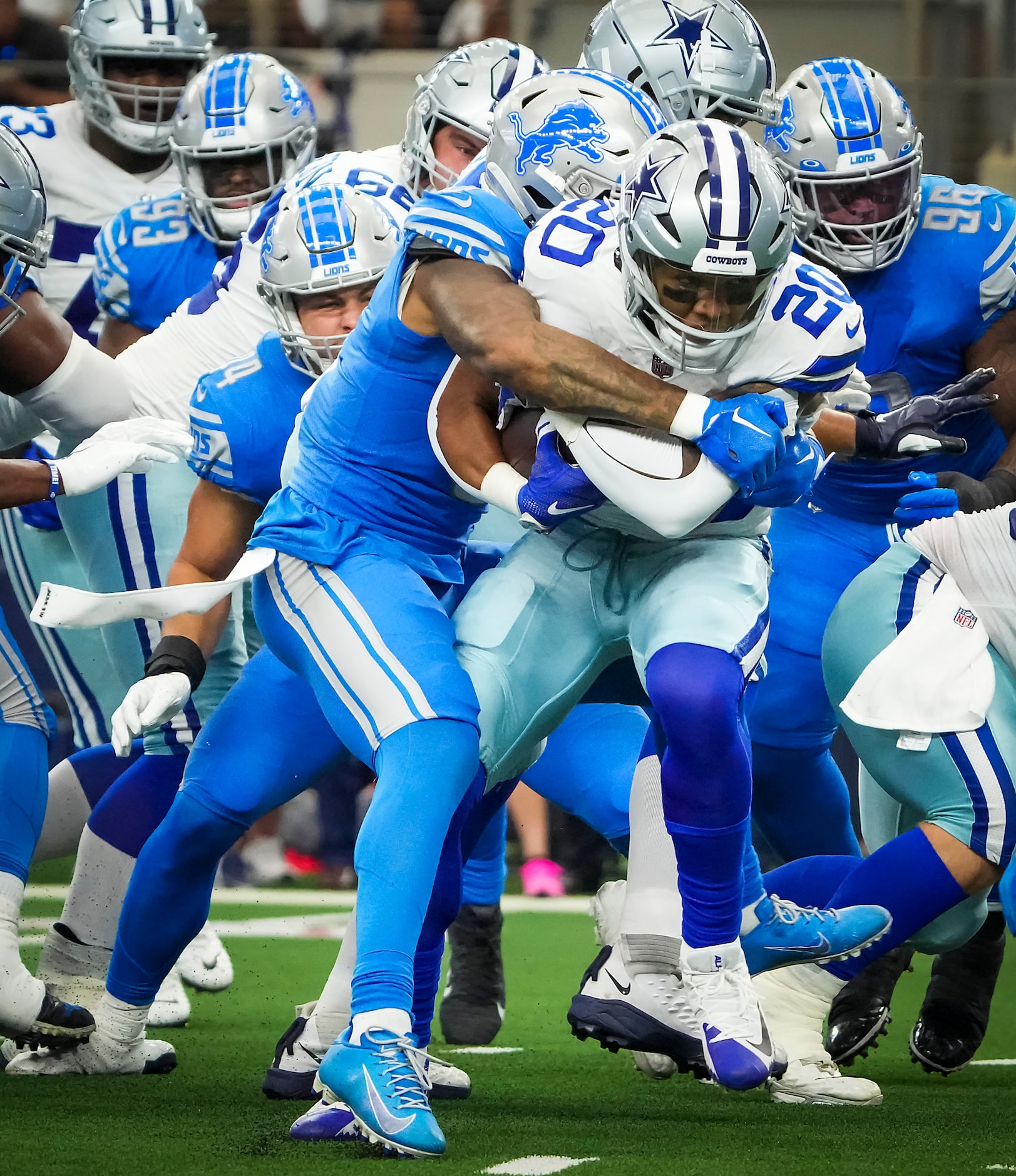 Dallas Cowboys running back Tony Pollard (20) is brought down by the Detroit Lions defends...