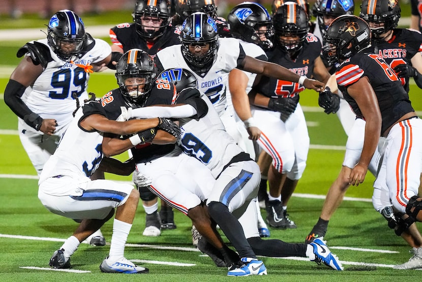 Rockwall running back AJ Hatcher (22) is wrapped up by the North Crowley defense during the...