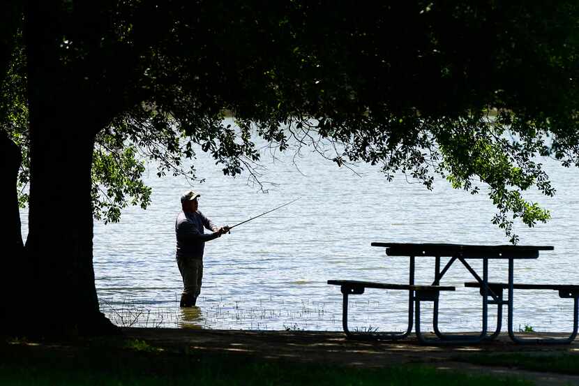 Rudy Sanchez of Dallas casts a line while fishing at Lake Tawakoni State Park on Tuesday,...