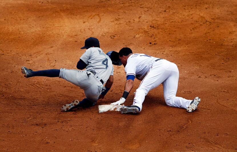 Texas Rangers left fielder Carlos Gomez (14) slides safely into second ahead of the...