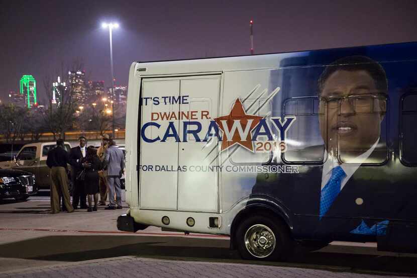 
Dwaine Caraway huddled with supporters and staffers in the parking lot behind a campaign...