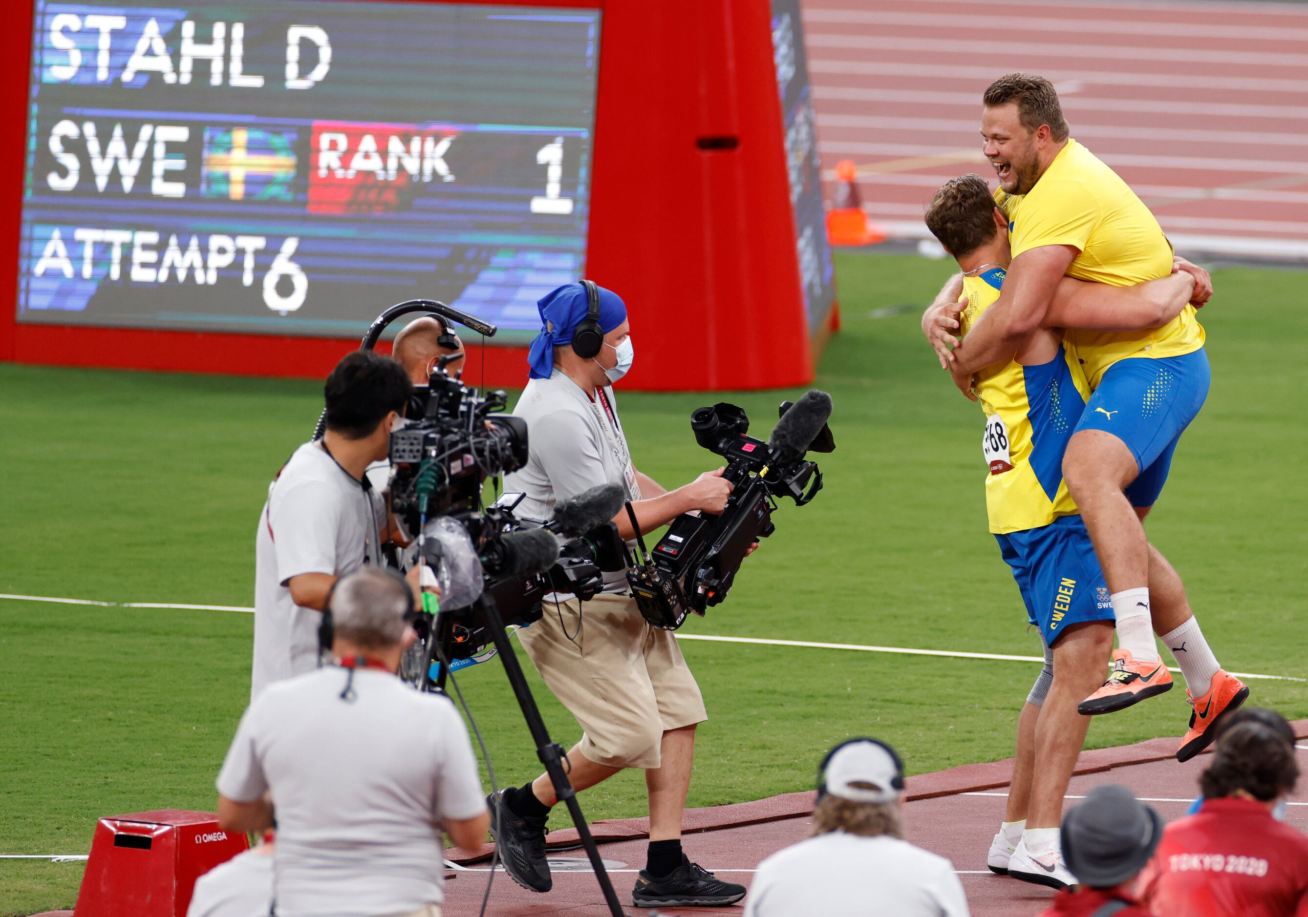 Sweden’s Daniel Stahl is lifted up by Sweden’s Simon Pettersson after the two took first and...