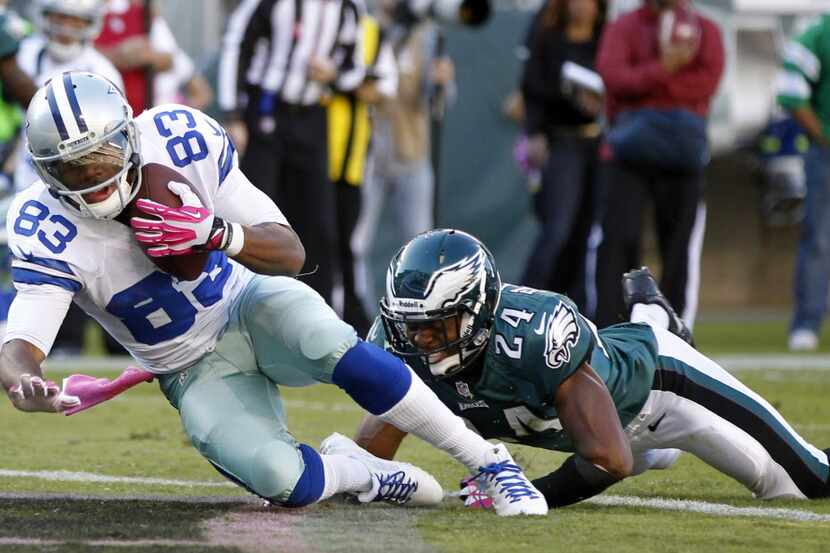 Dallas Cowboys wide receiver Terrance Williams (83) catches and scores a touchdown in front...