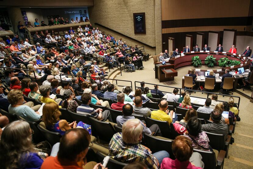 The crowd looks on during a joint meeting of the Plano City Council and the Planning and...