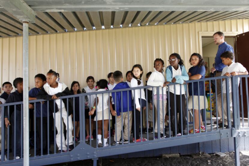 Third-grade students lined up to enter Daniel Balkema's music class in a portable classroom...