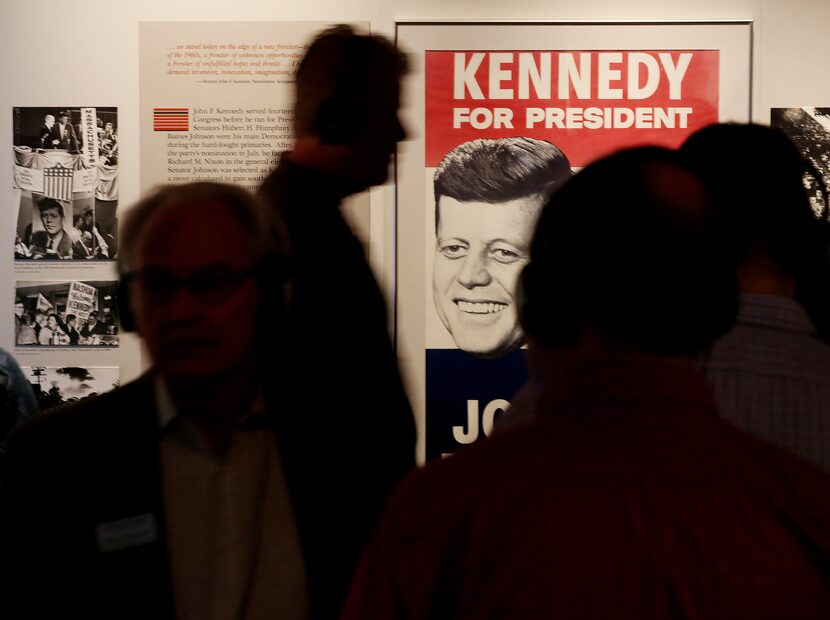 Visitors study a display at the Sixth Floor Museum in what was once the Texas Schoolbook...