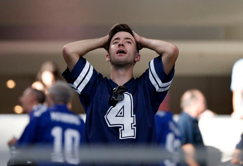 A Dallas Cowboys fan reacts to a 20-19 loss to New York Giants at AT&T Stadium in Arlington,...