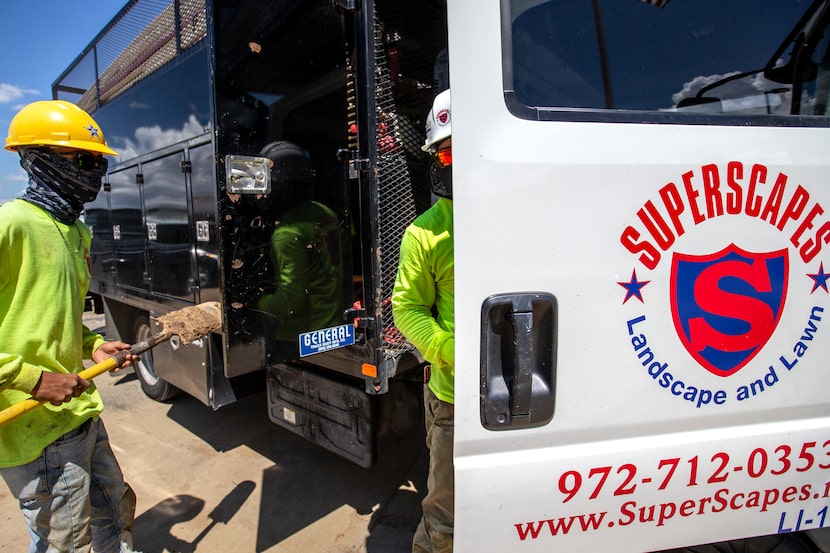 Superscapes employees gather tools to work at a landscaping job site at Lakeside Center in...