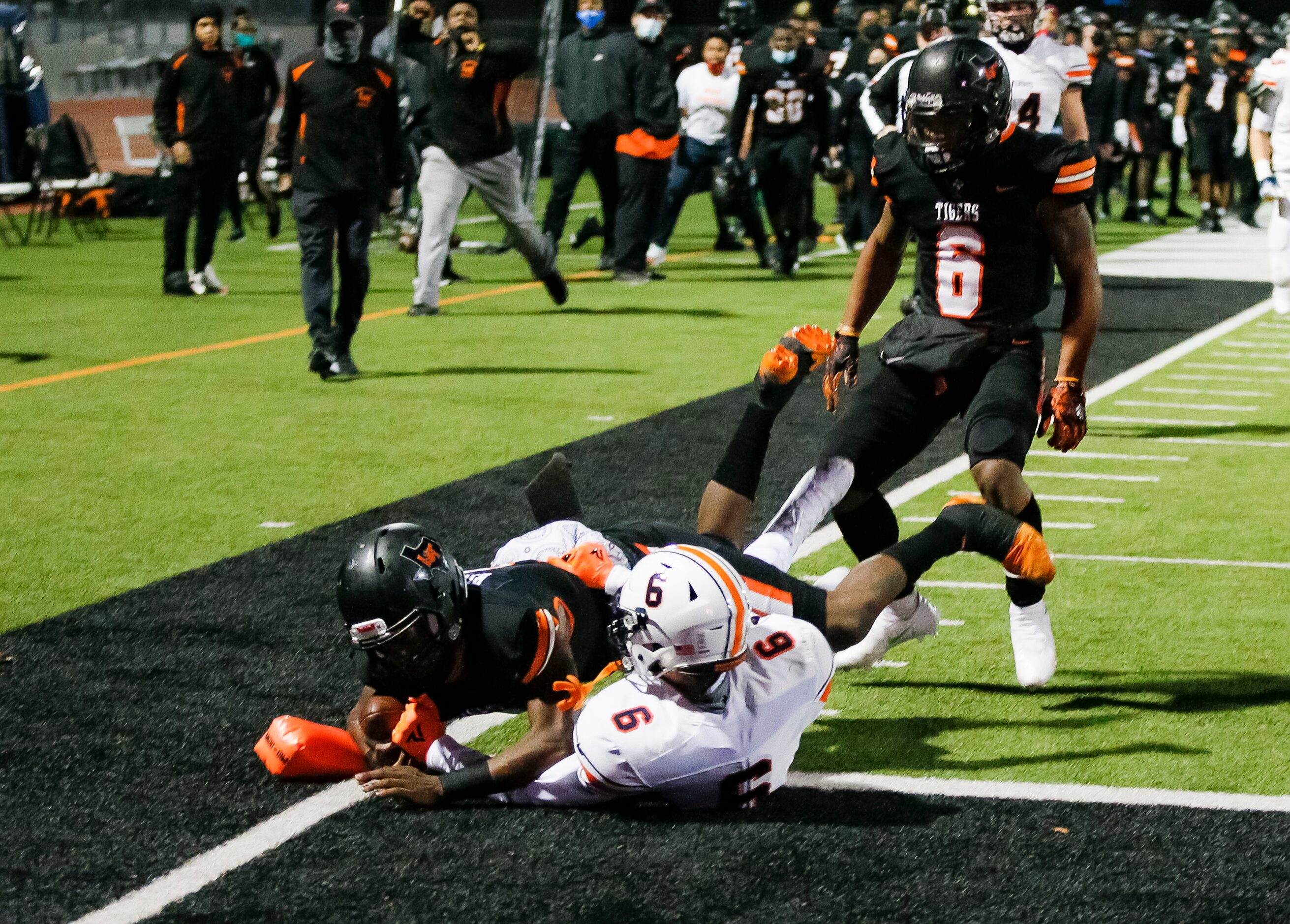 Lancaster junior quarterback Glenn Rice Jr. (3) battles past Wakeland senior defensive back...