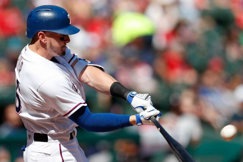 Texas Rangers' Ryan Rua connects for a solo home run against the Boston Red Sox during the...