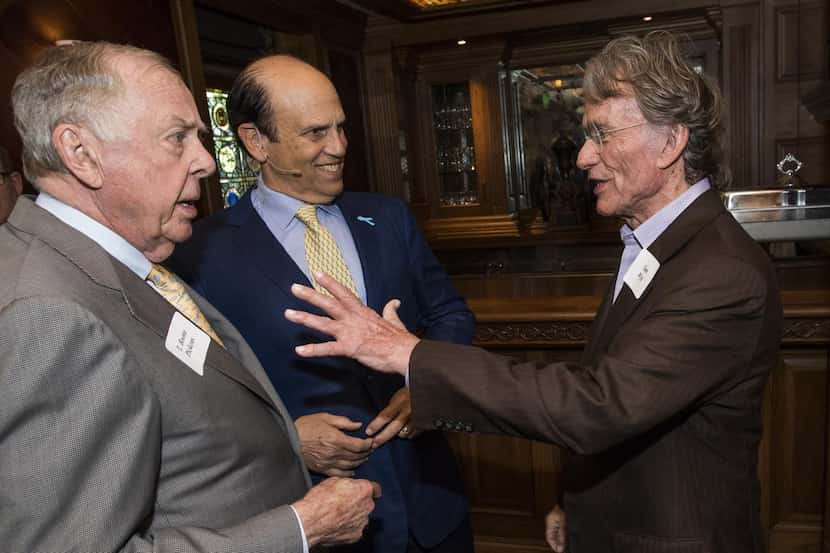 T. Boone Pickens  (left) and Mike Milken chatted with Sam Wyly at a June 3 luncheon. Milken...