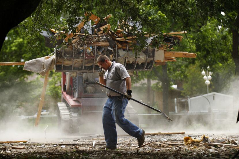 Jeffery Horst of Christian Aid Ministries helped clear around a demolished home Friday. The...