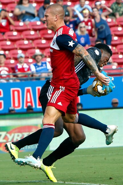 FC Dallas' Zdenek Ondrasek (13) collides with New York City FC goal keeper Sean Johnson (1)...