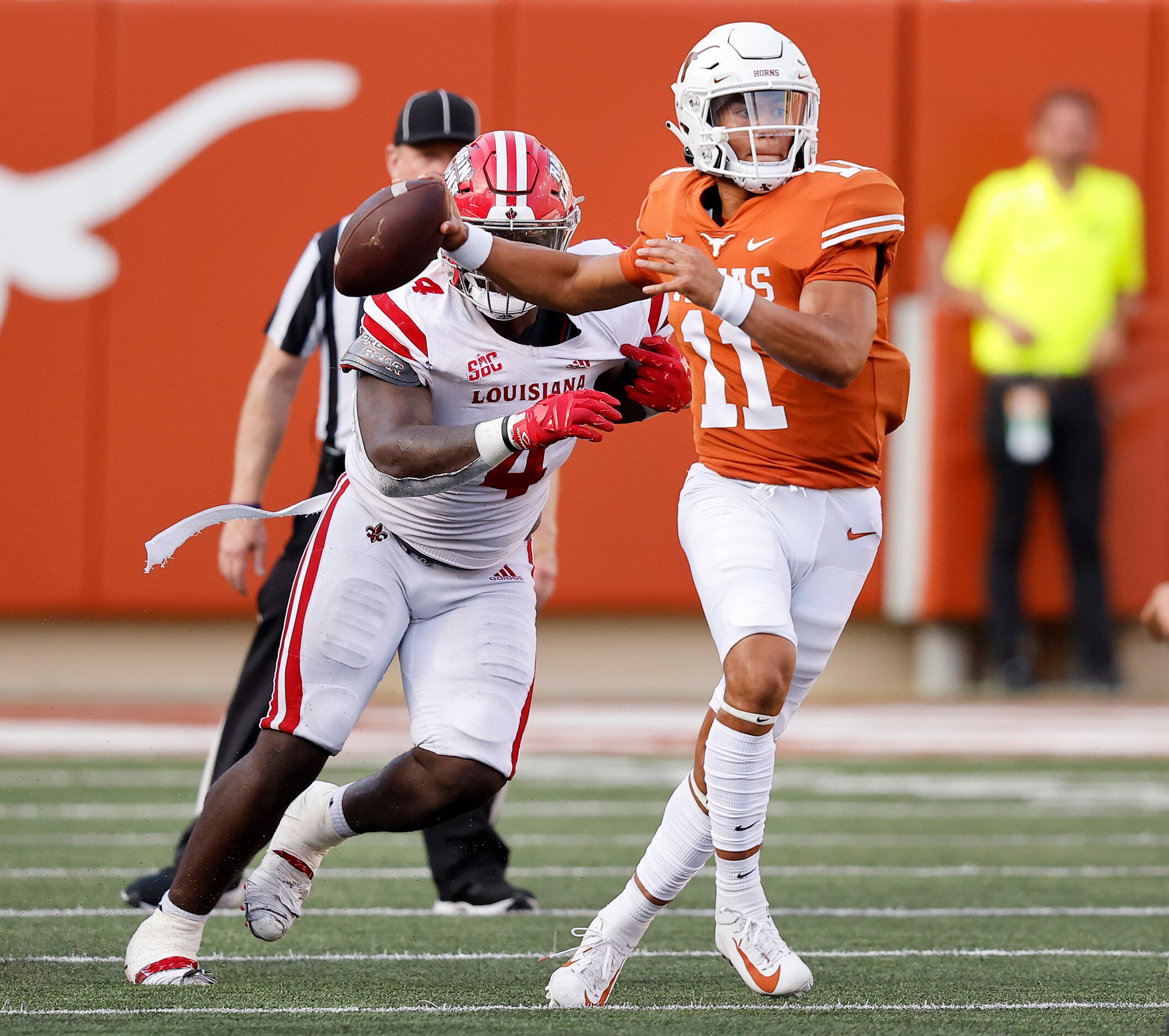 Texas Longhorns quarterback Casey Thompson (11) escapes the pass rush of Louisiana-Lafayette...