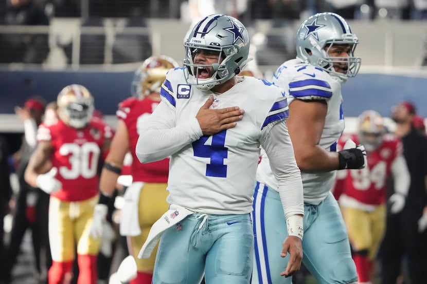 Dallas Cowboys quarterback Dak Prescott (4) celebrates after throwing a touchdown  pass to...
