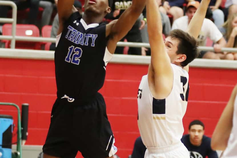 Trinity Christian School Tyreek Smith (12) scores against Second Baptist School Kyle Hannon...