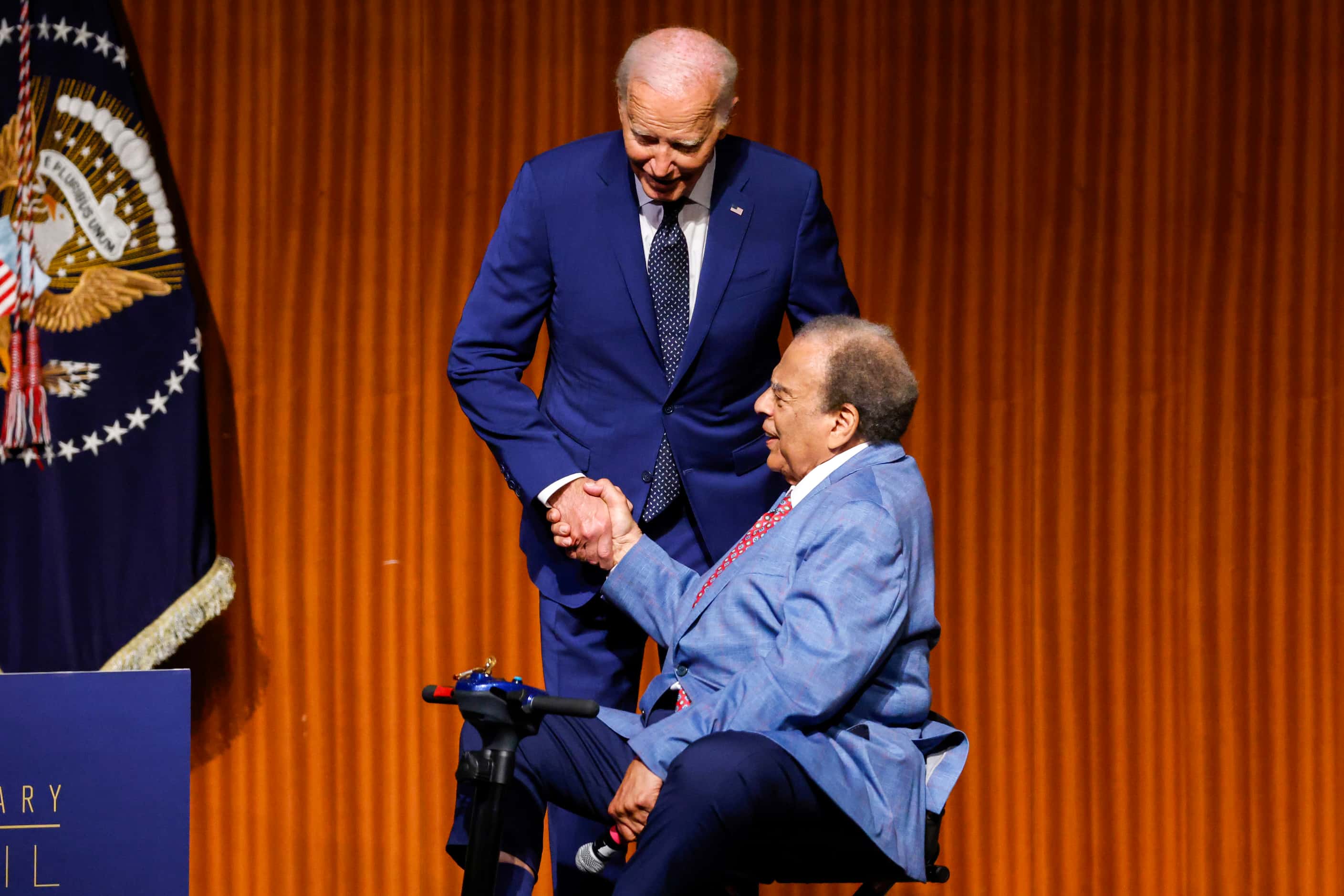President Joe Biden shakes hands with Ambassador Andrew Young before giving the keynote...