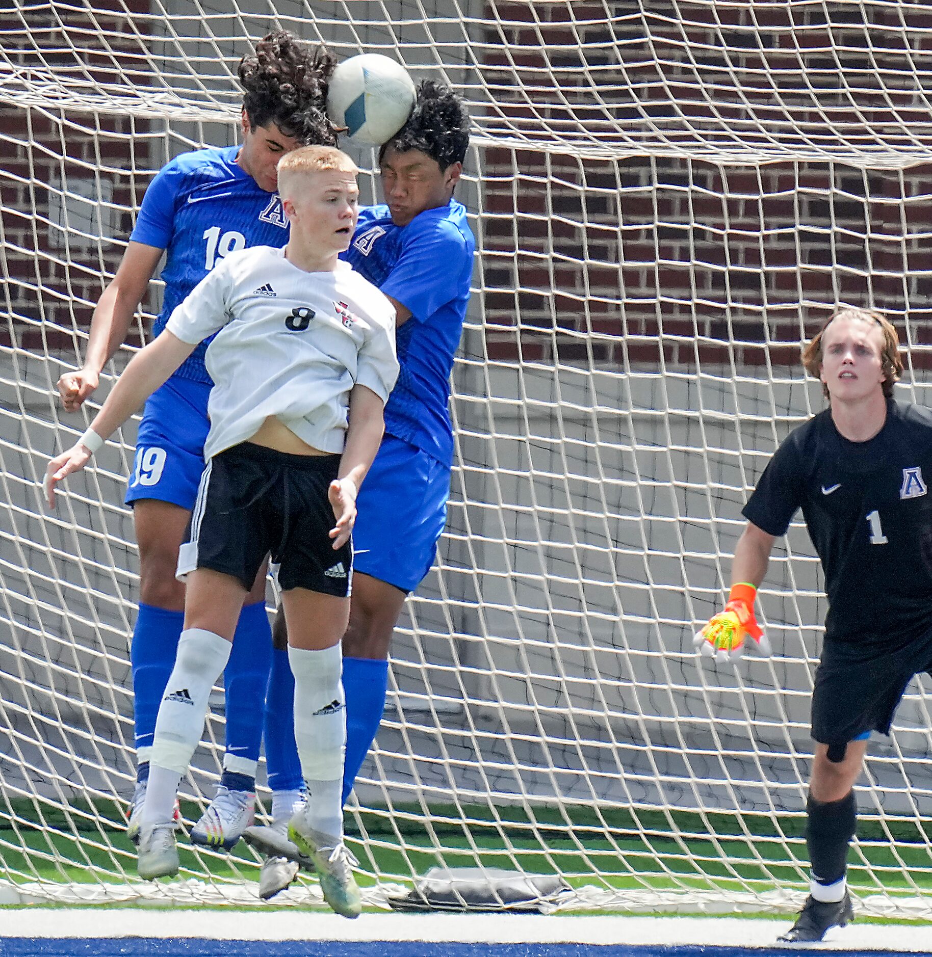 Lake Highlands forward Evan Bernhard (8) fights for a header against Allen defender Suliman...