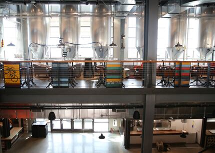 Beer fermentation tanks run the length of Legacy Hall's westernmost side, near seating where...