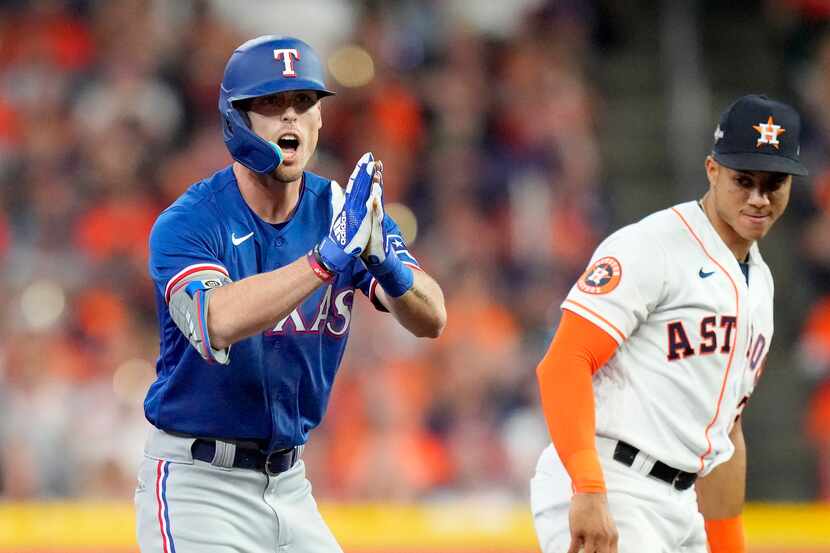 Texas Rangers’ Evan Carter celebrates his double as Houston Astros shortstop Jeremy Pena (3)...