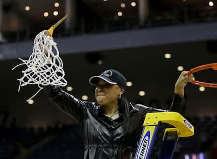 South Carolina head coach Dawn Staley holds up the net after beating Florida State, 71-64,...