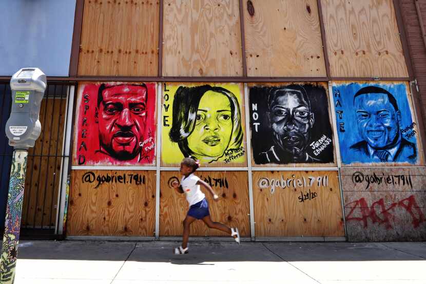 A mural painted in Deep Ellum days after George Floyd's death May 25 depicts, from left:...