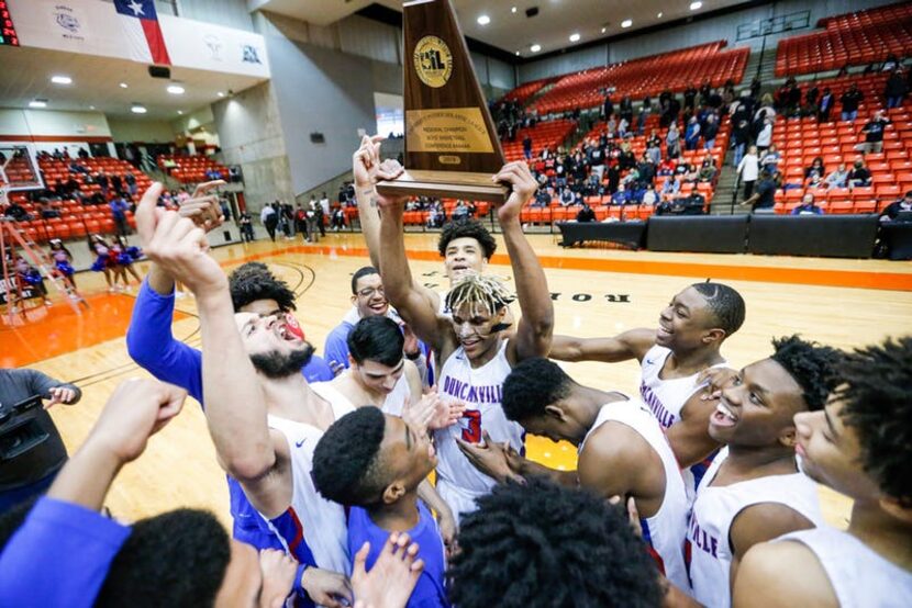 Duncanville senior guard Jahmi'us Ramsey (3) celebrates with his teammates a 66-62 overtime...