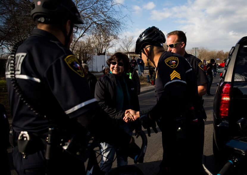 Gubernatorial candidate and former Dallas County Sheriff Lupe Valdez (center) shakes hands...