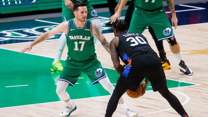 Dallas Mavericks guard JJ Redick (17) blocks New York Knicks forward Julius Randle (30) in...