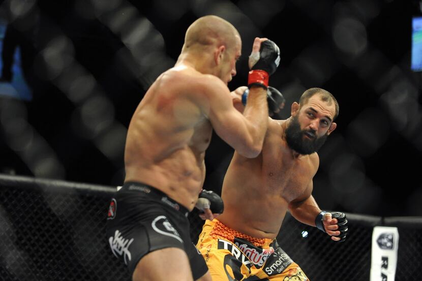 Nov 16, 2013; Las Vegas, NV, USA; Georges St-Pierre (red gloves) fights against Johny...