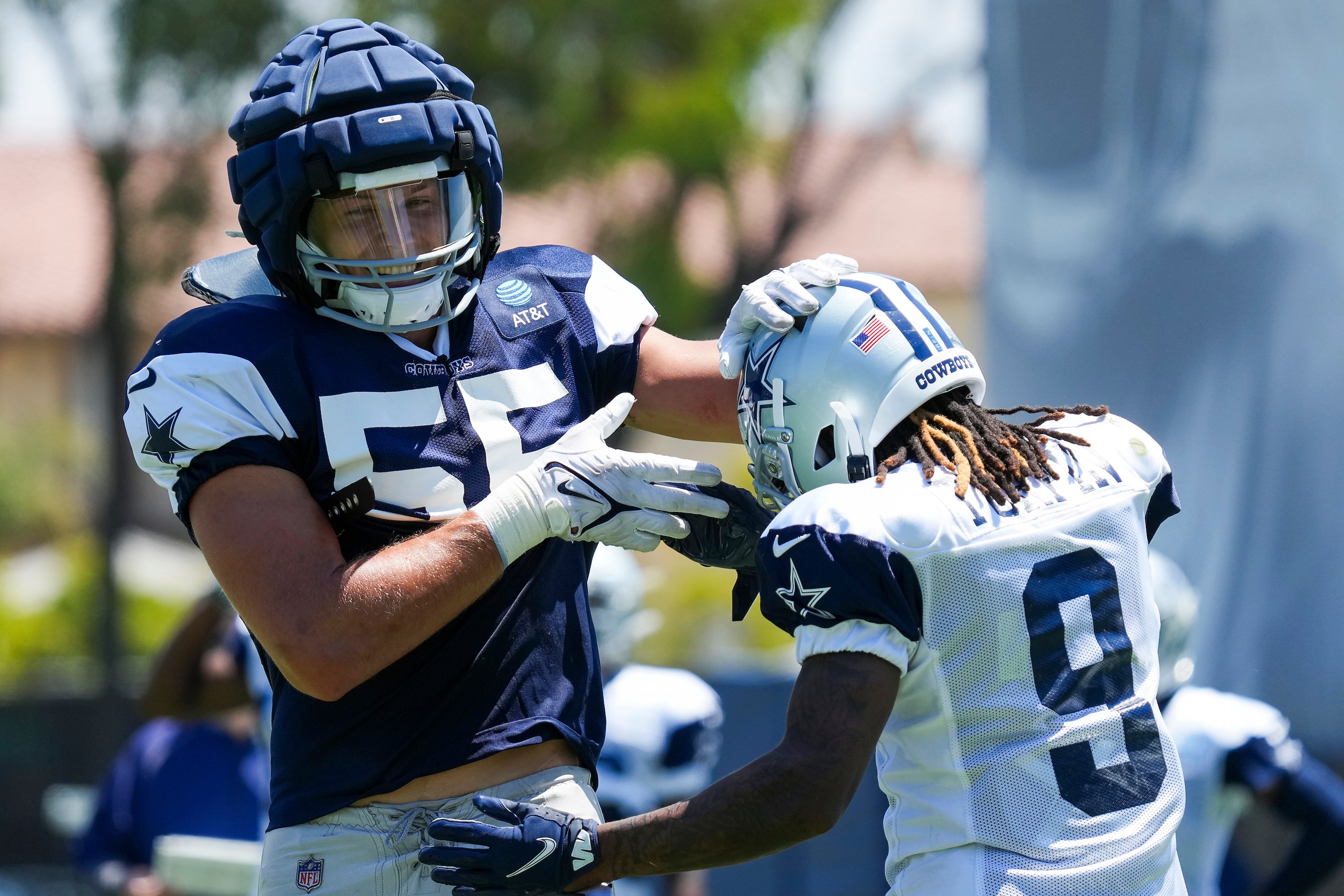 Dallas Cowboys outside linebacker Leighton Vander Esch (55) pats wide receiver KaVontae...