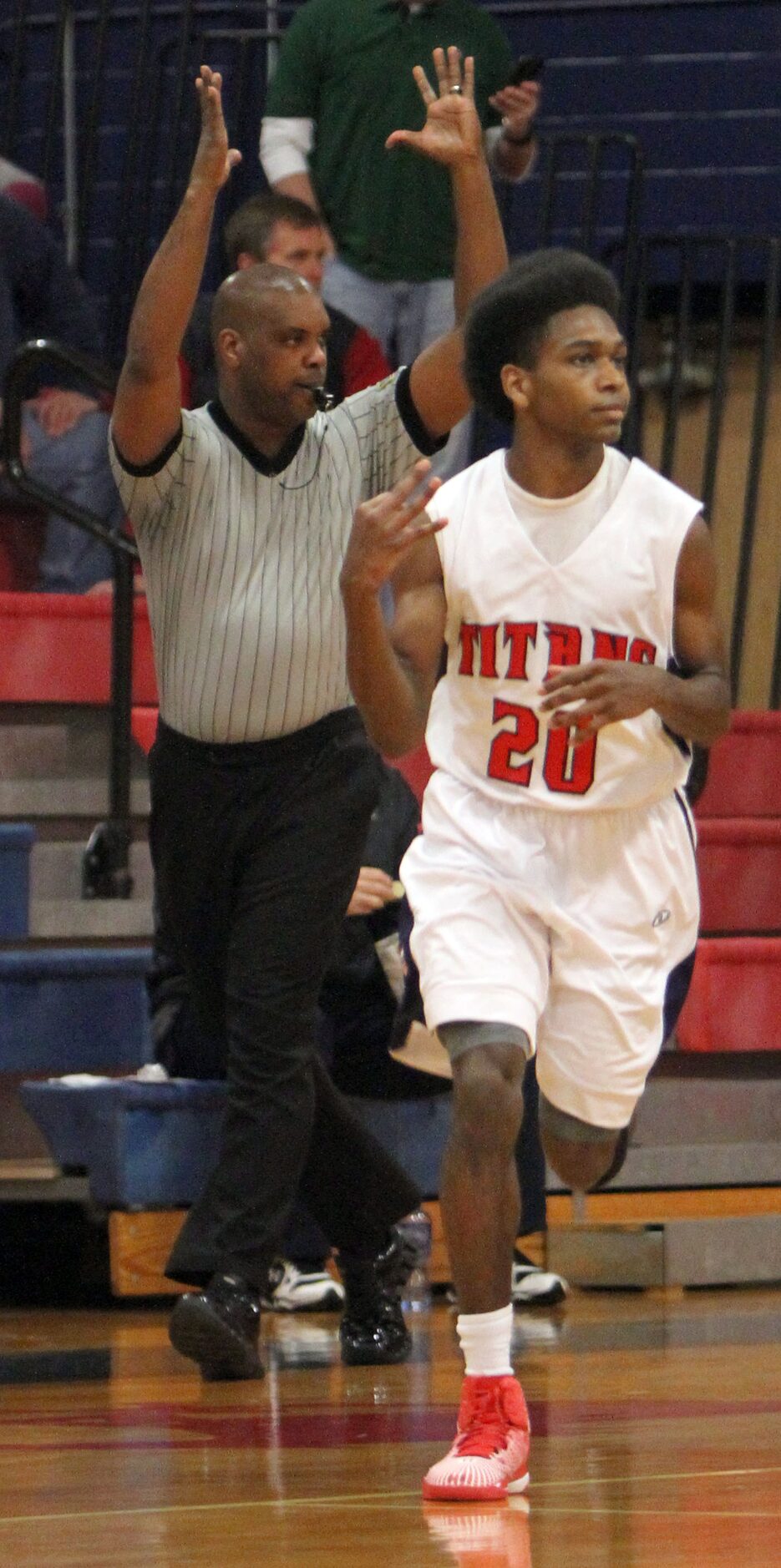 Frisco Centennial guard Mason Smith (20) acknowledges to his team's bench as a referee...