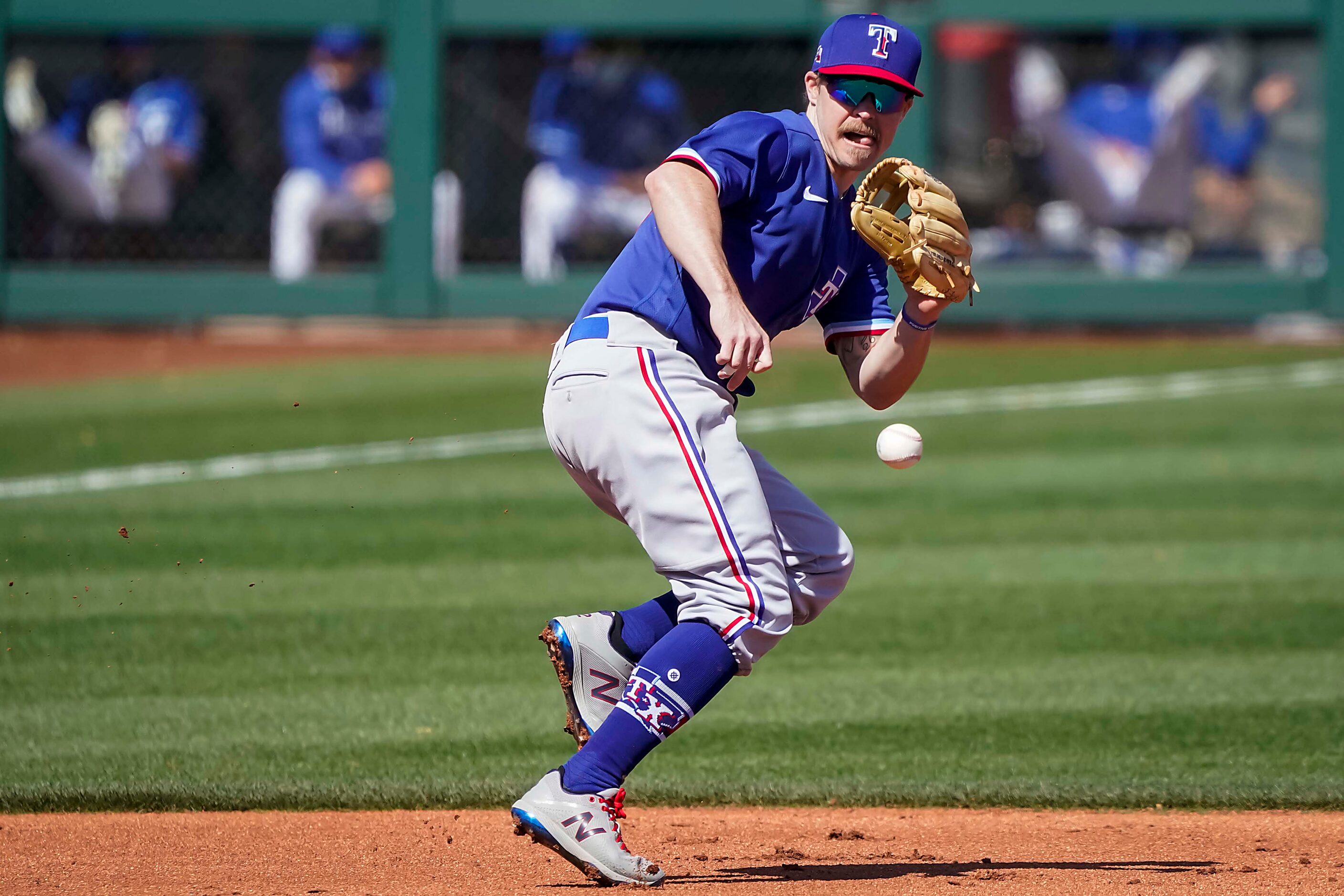 Texas Rangers third baseman Brock Holt makes the play on a grounder off the bat of Kansas...