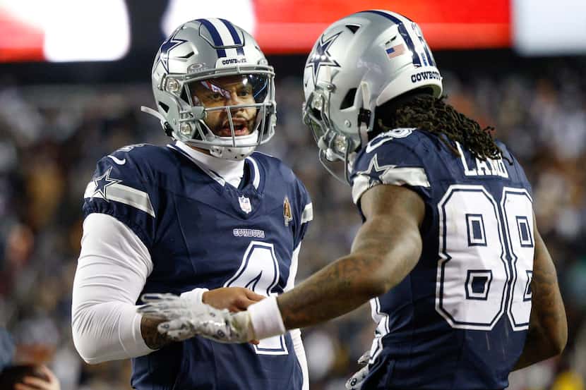 Dallas Cowboys quarterback Dak Prescott (4) celebrates a touchdown with wide receiver CeeDee...