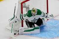 Dallas Stars goaltender Jake Oettinger stops a shot in the first period of Game 3 of an NHL...