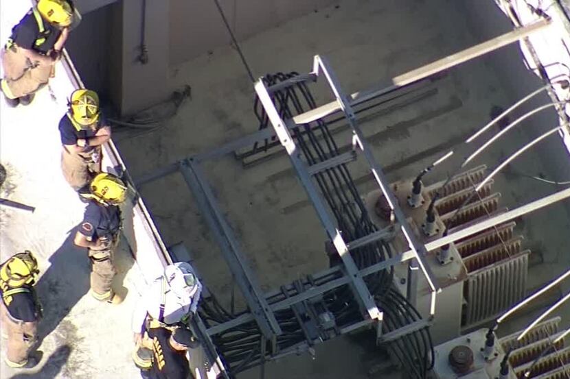  Fire crews look into a transformer well where a man died after being electrocuted and...