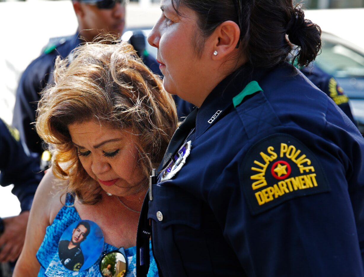 Members of the Dallas Police Department comforted Valerie Zamarripa, mother of Patrick...