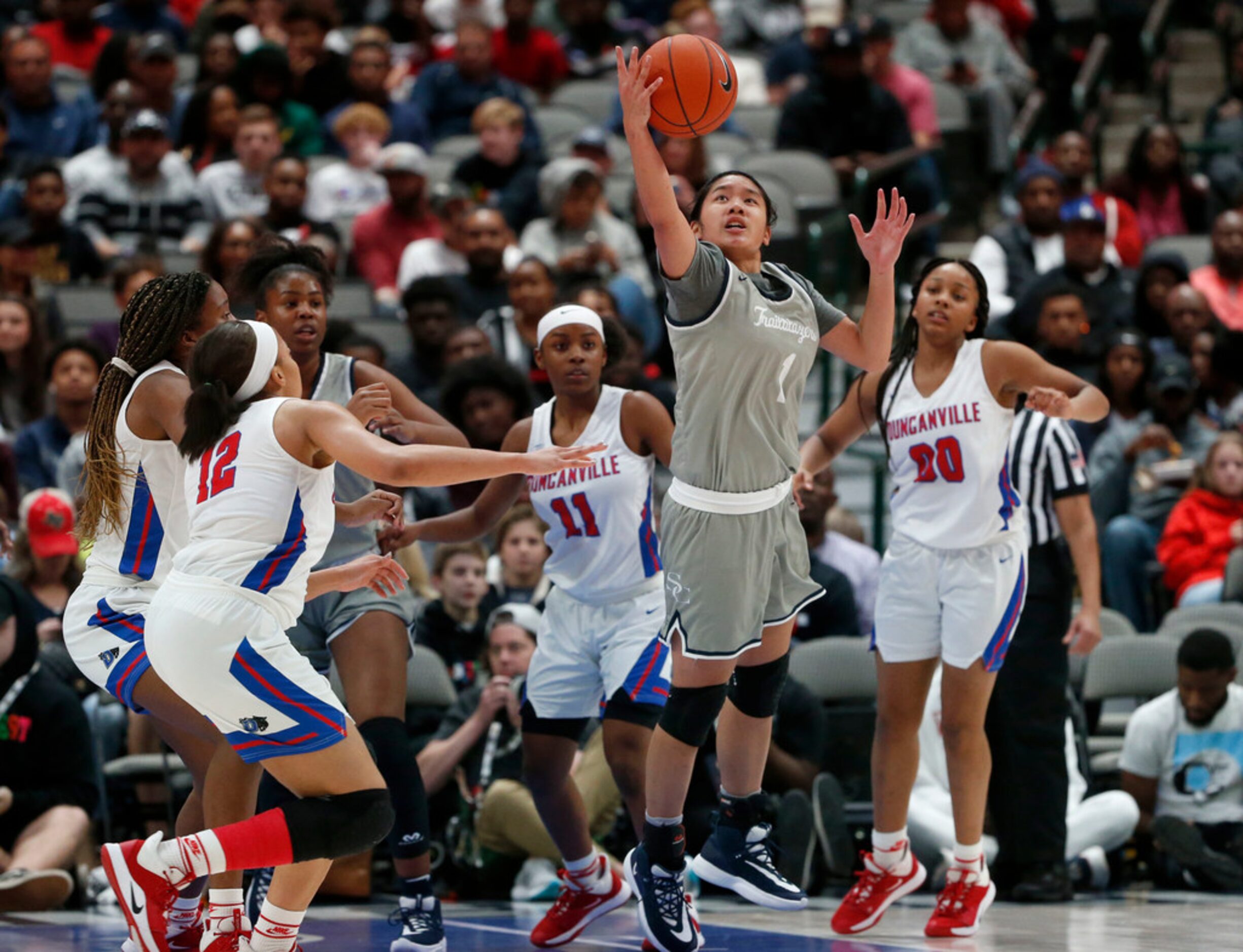 Sierra Cayon's Vanessa DeJesus (1) grabs a rebound in front of Duncanville's Zaria Rufus...