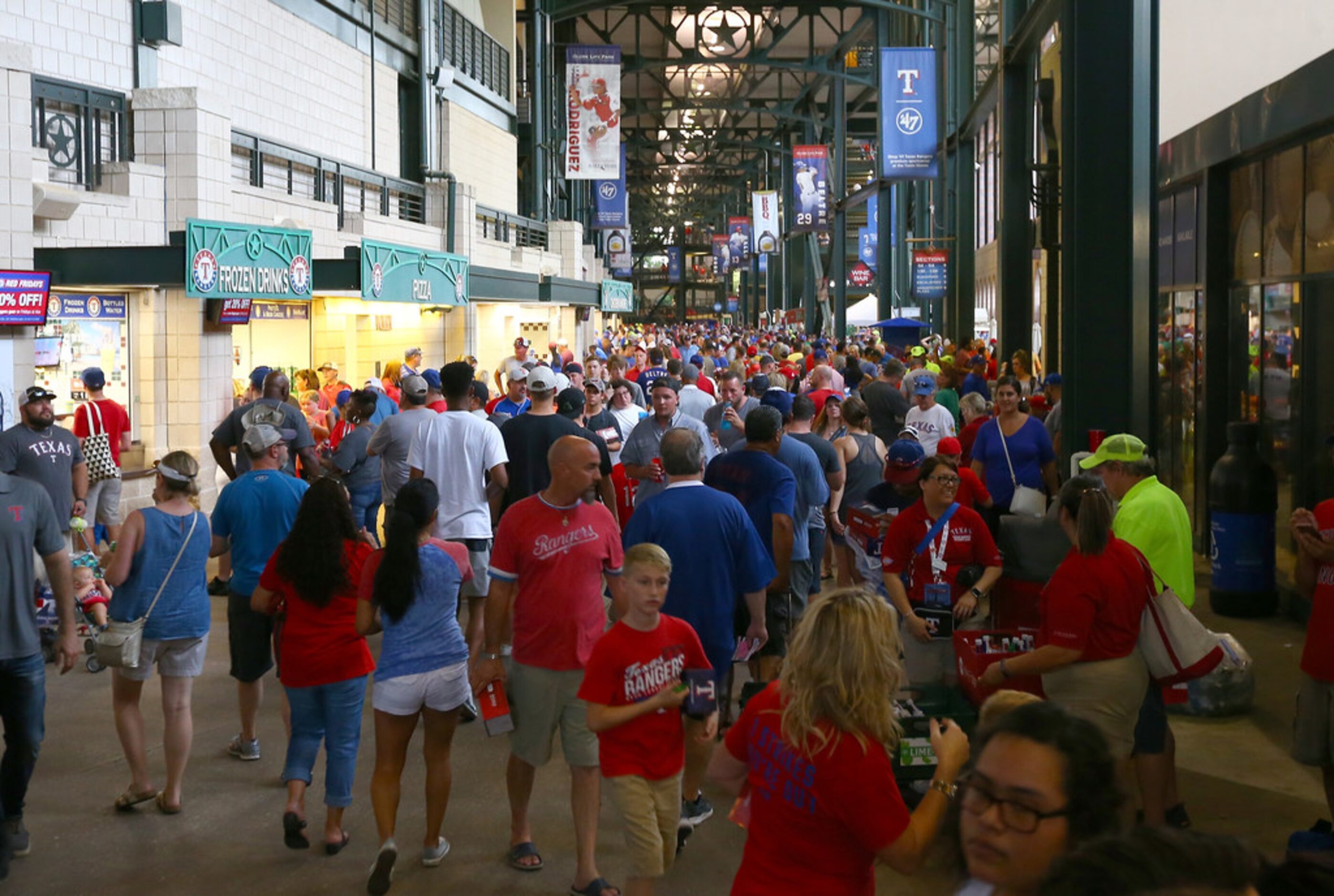 ARLINGTON, TX - AUGUST 18: Fans taking shelter from the grandstands during a rain delay...