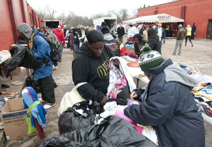 The homeless and needy looked through donated clothing as they attended the Christmas Day...