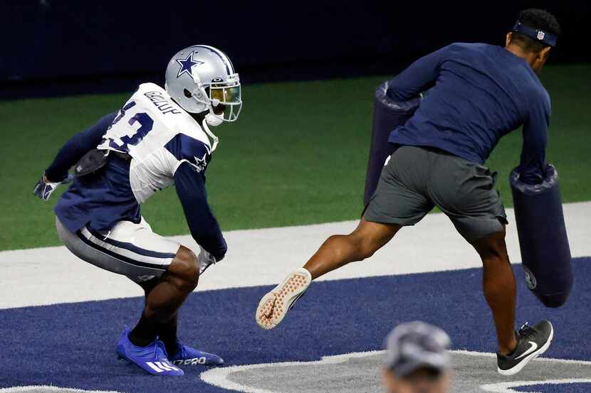 Dallas Cowboys wide receiver Michael Gallup (13) pushes away a coach as he runs a pass route...