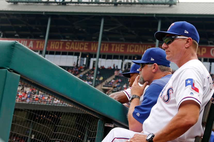 Texas Rangers manager Jeff Banister (28) watches the action from the dugout during the...