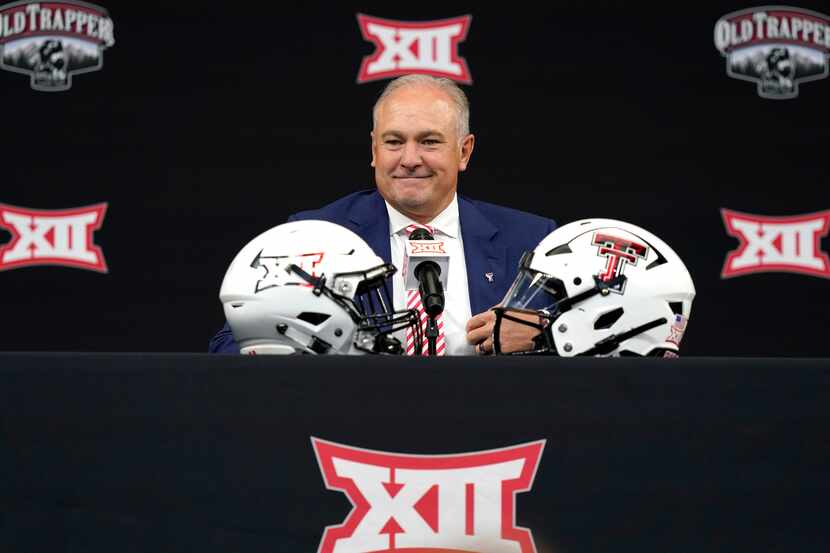 Texas Tech head coach Joey McGuire smiles before speaking to reporters at the NCAA college...