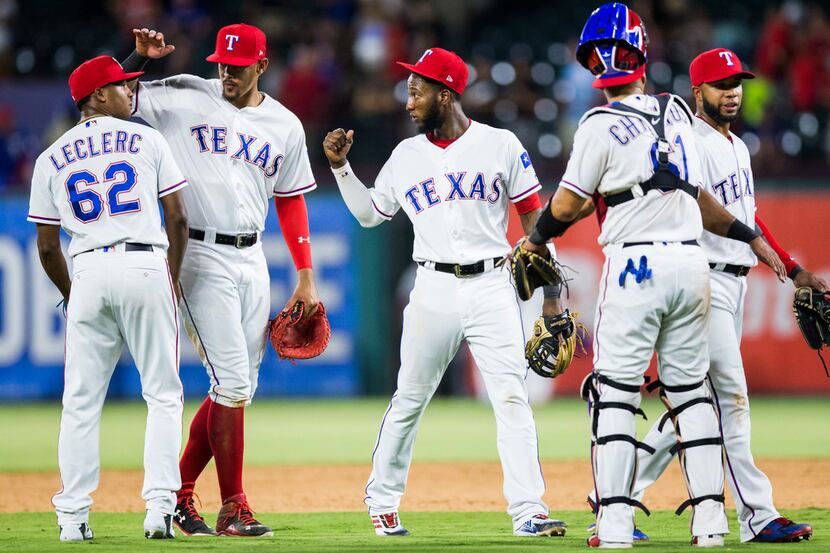 The Texas Rangers celebrate after an 8-6 win over the Los Angeles Angels on Thursday, August...