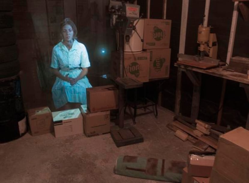 
An image of an actress portraying Lee Harvey Oswald’s wife, Marina, is projected in the...