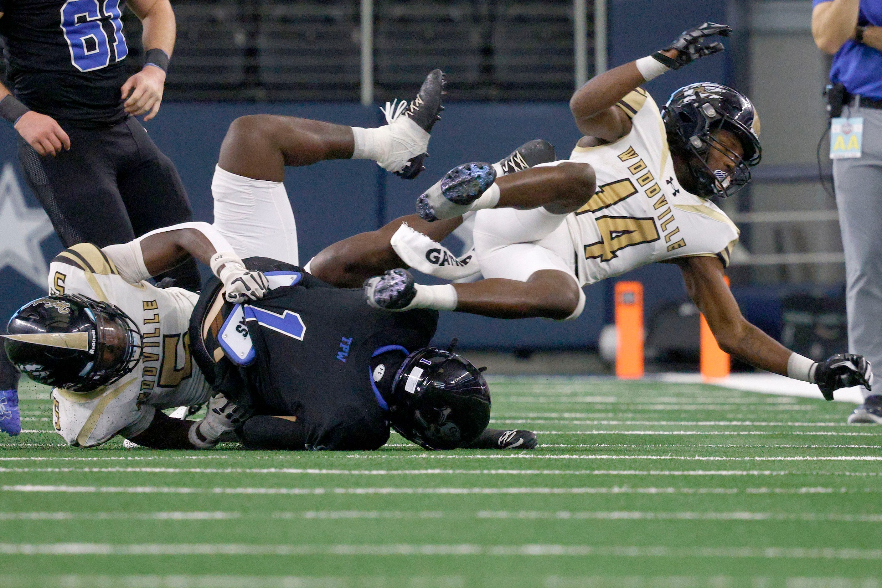 Gunter's Brock Boddie (1) tangles with Woodville's Jacob Hyder (5) and Woodville's Savon...