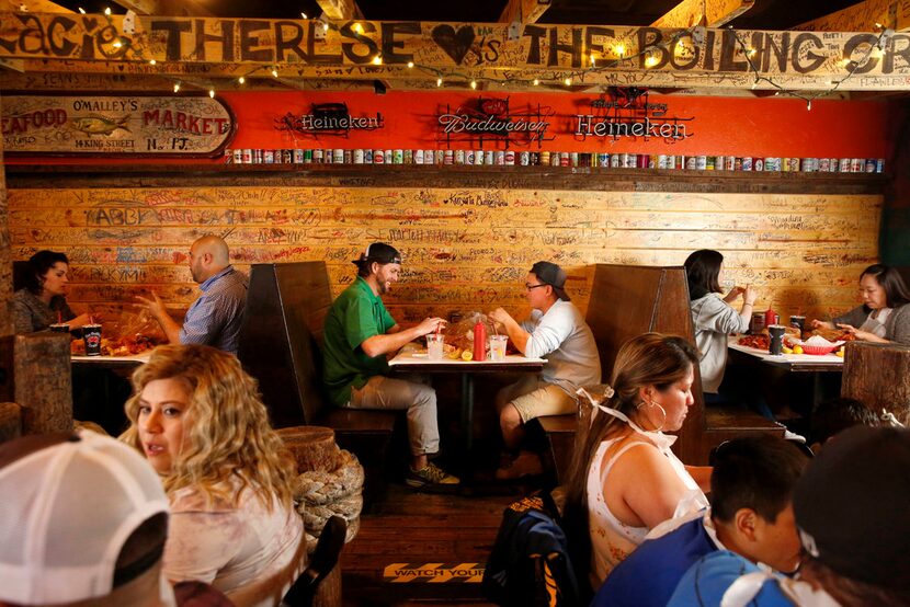 People eat seafood at The Boiling Crab in Dallas.