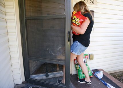 Jeanne Marie Boyne, a volunteer for the Seniors' Pet Assistance Network brings dog treats...